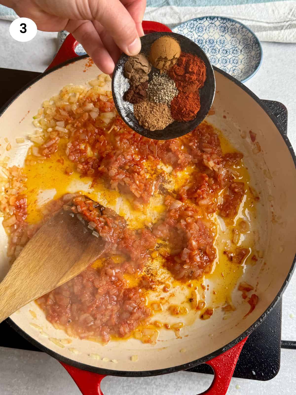 Adding the spices to the pan.