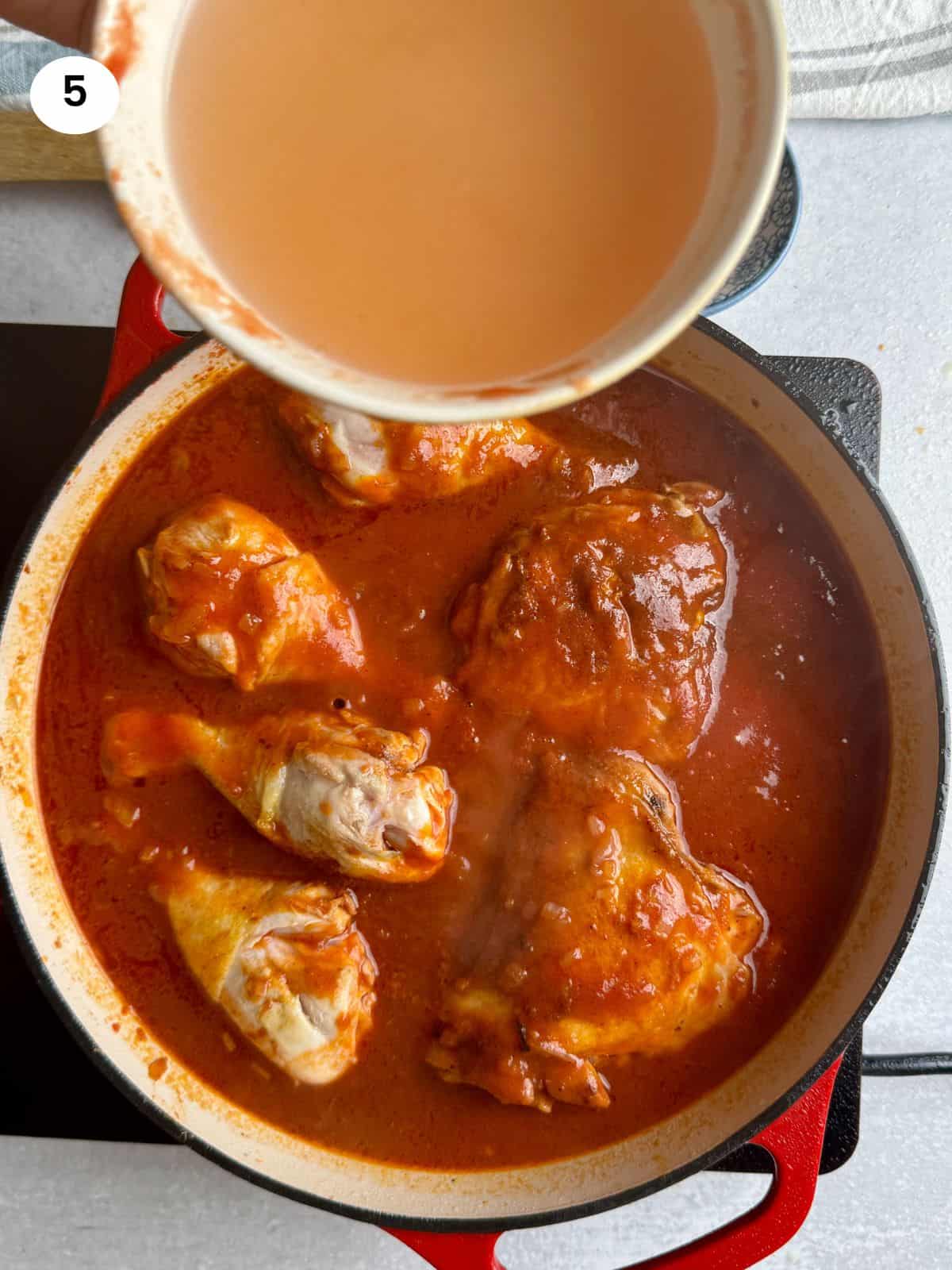 Adding water to the sauce.