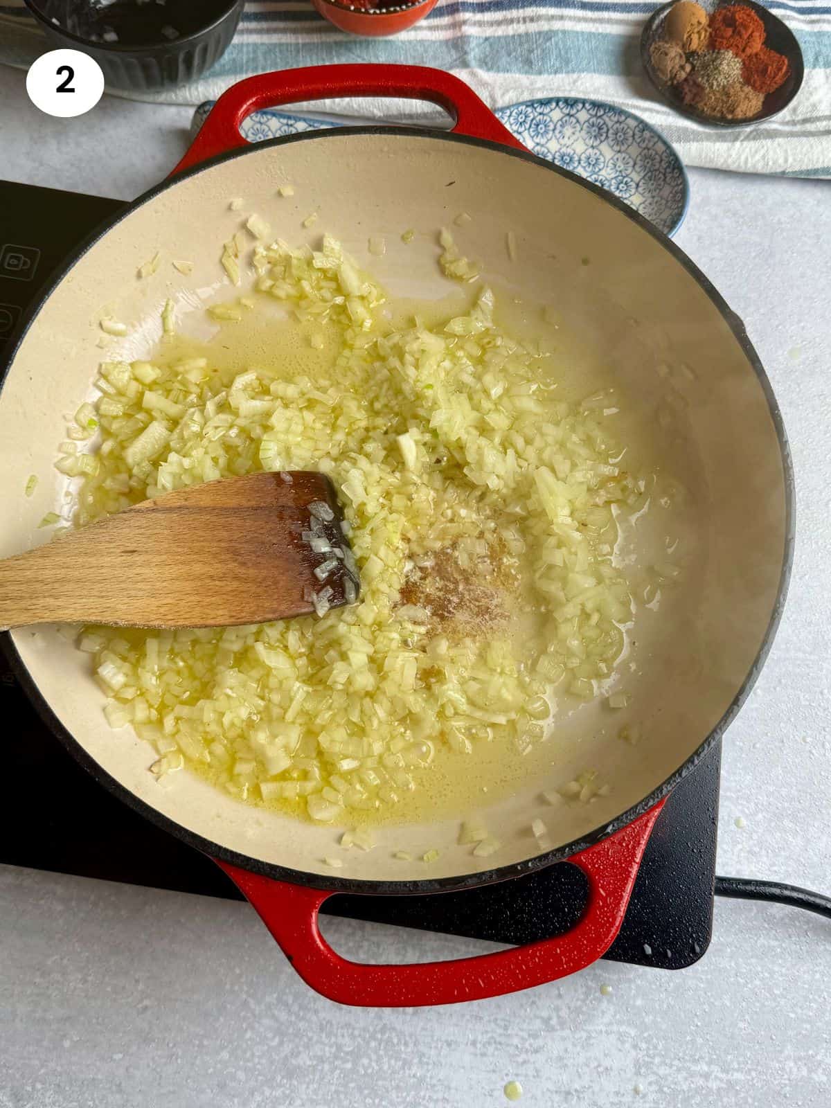Cooking the onion until soft and translucent.