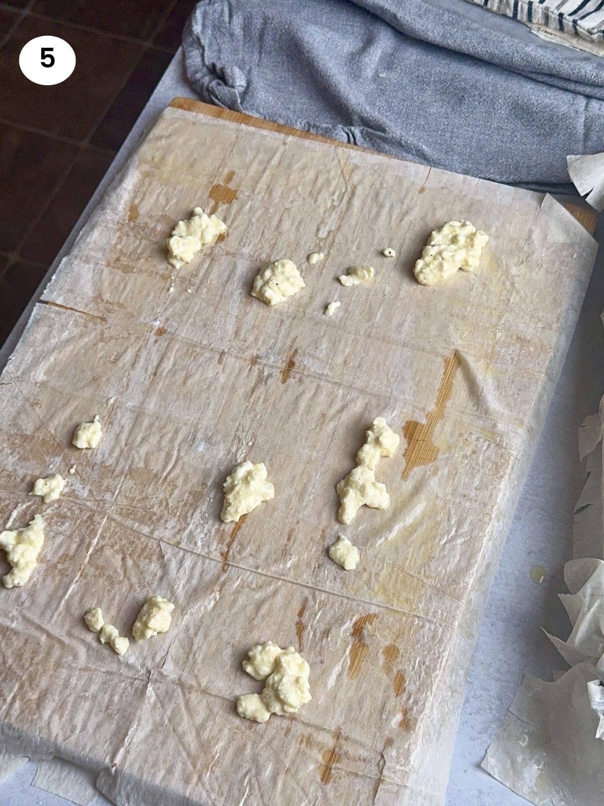 Phyllo sheet brushed with butter and some spoons of cheese filling.