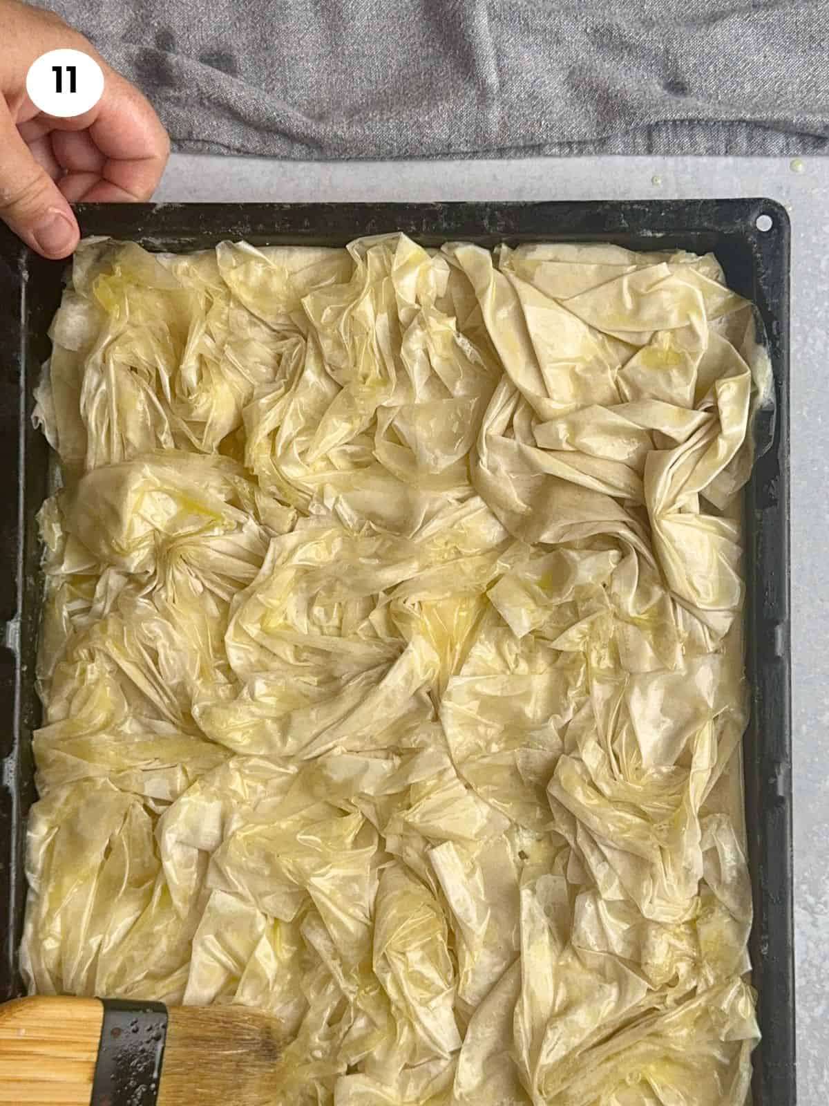 Brushing the top with the remaining butter.