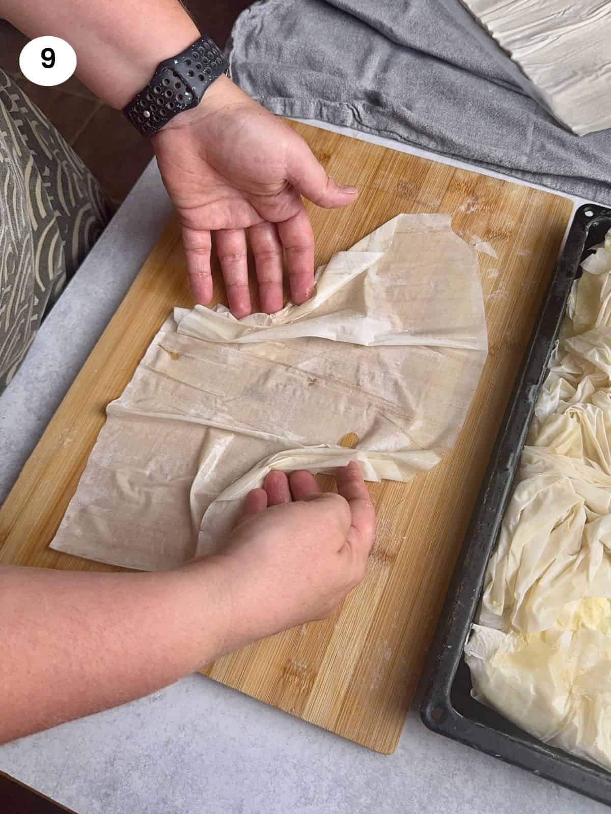 Folding the corners of the phyllo towards the center.