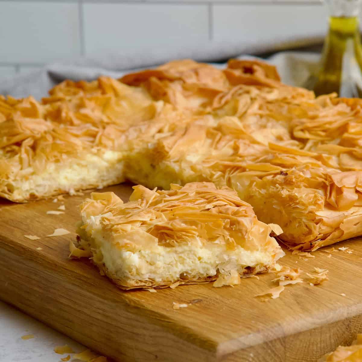 Greek phyllo crinkle cheese pie on a wooden board.