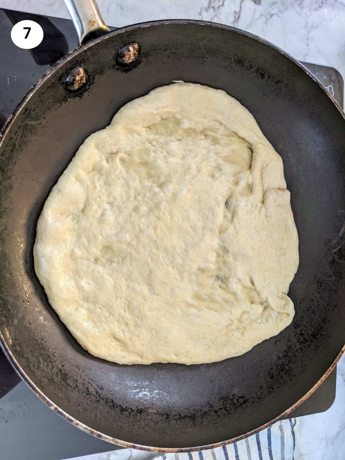 Pita bread on heated pan.