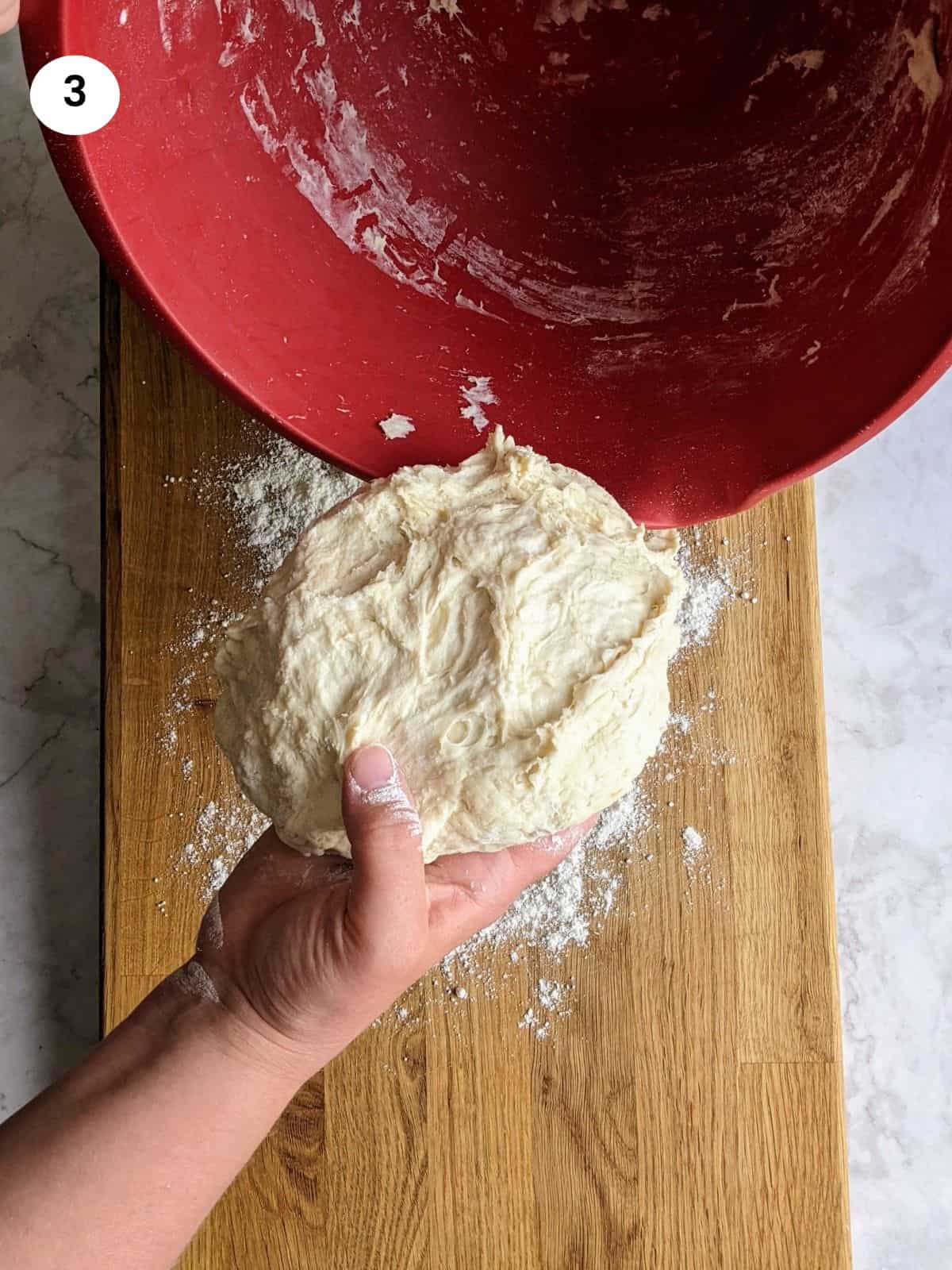 Preparing the dough on a floured surface before resting.