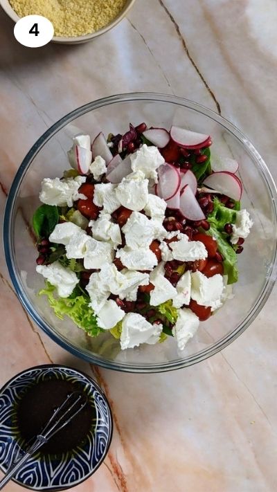 Adding all salad ingredients to a bowl.