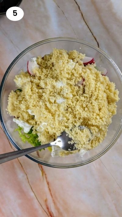 Adding the cooked couscous to the salad