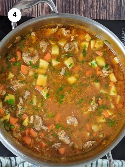 Adding the potatoes, carrots and parsley to the pot.