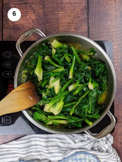 Adding the celery greens to the pot.