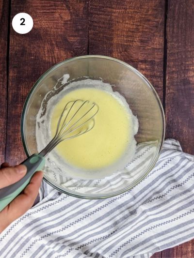 Adding the egg yolk and lemon juice to the bowl.