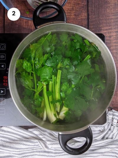 Boiling the celery leaves for a couple of minutes.