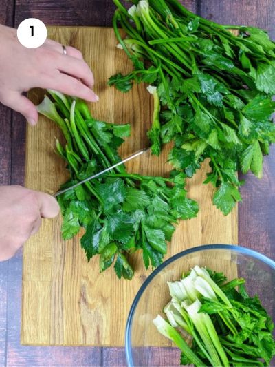 Cutting the celery greens into smaller chunks.