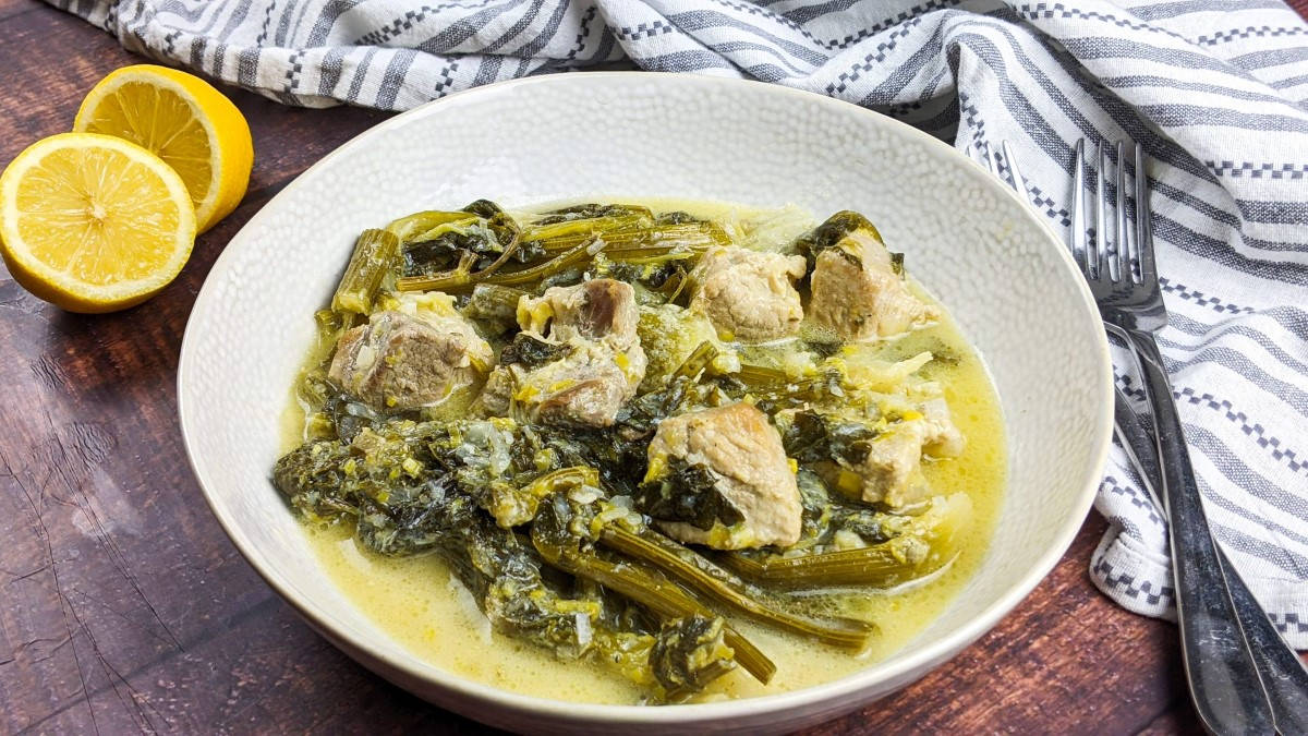 Greek pork and celery stew served in a white bowl.