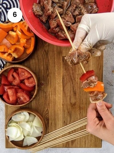 Assembling the pork skewers.