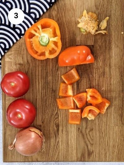 Cutting pepper slices for assembling the pork skewers.