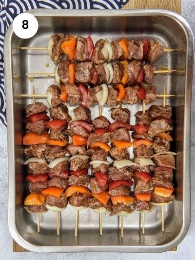 All pork skewers in the baking tray.