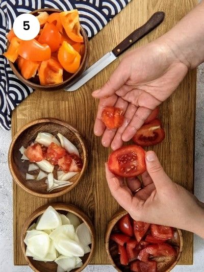 Removing the tomato flesh.