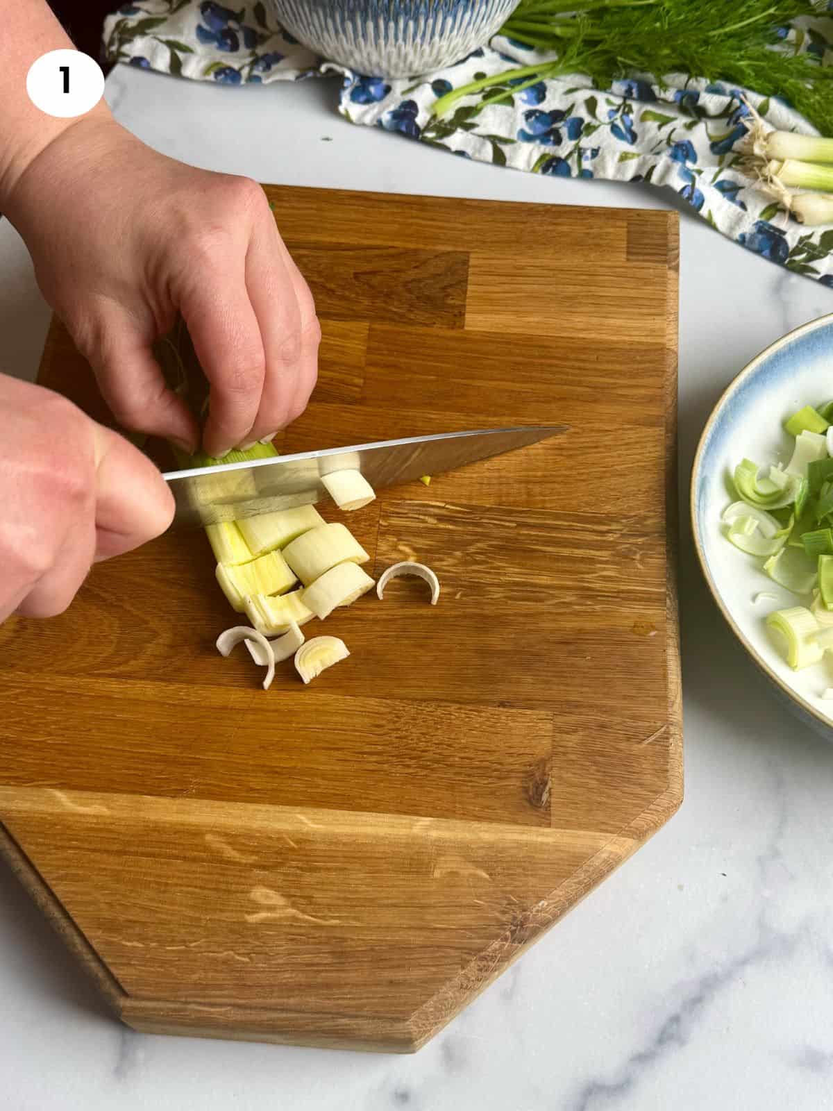 Cutting leeks into thick slices.