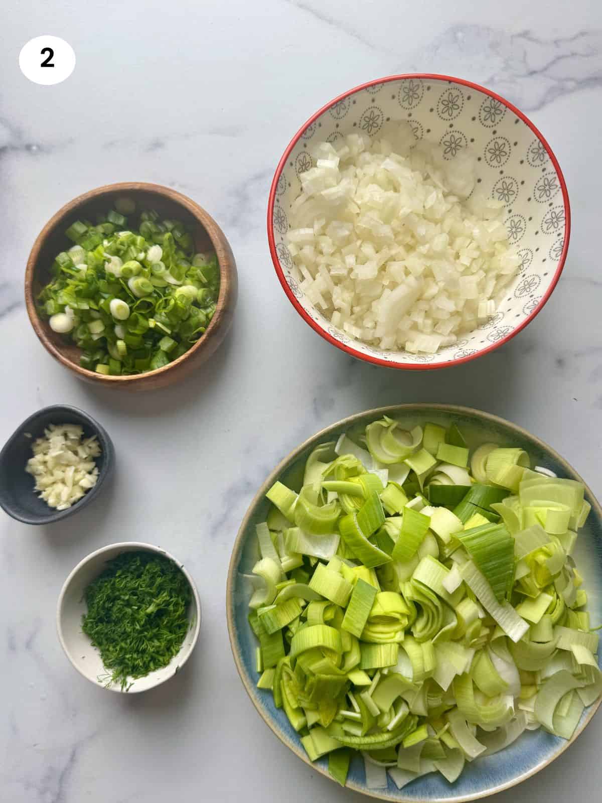 Chopped vegetables in bowls.