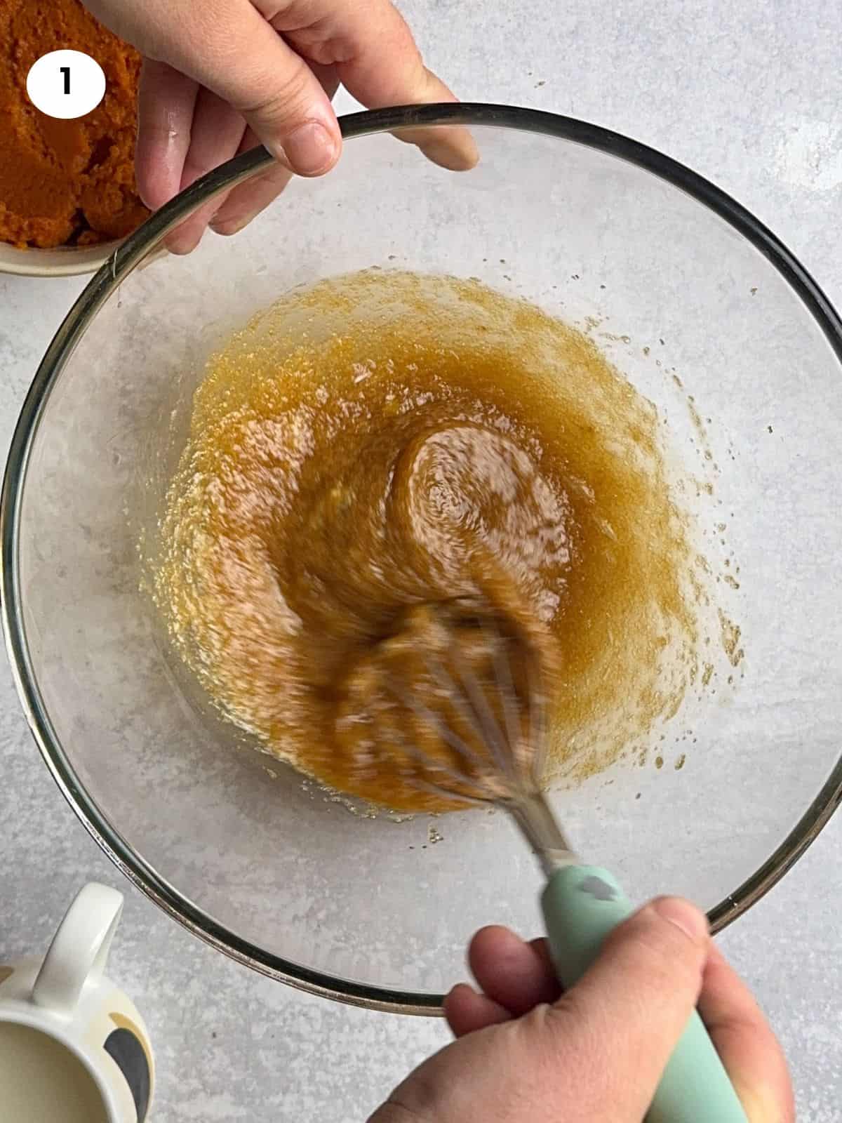 Mixing the eggs and sugar for the custard.
