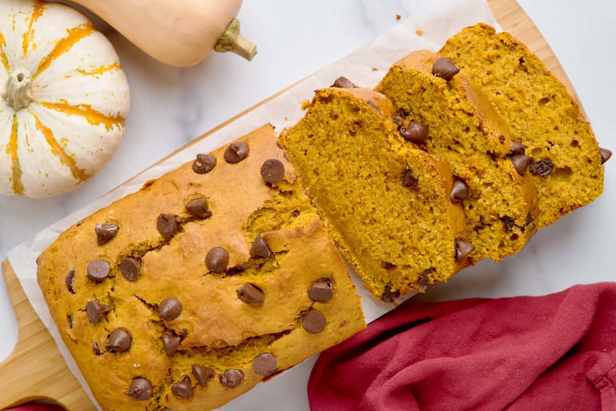 Banana pumpkin bread on a wooden board cut into slices Banana pumpkin bread on a wooden board cut into slices.
