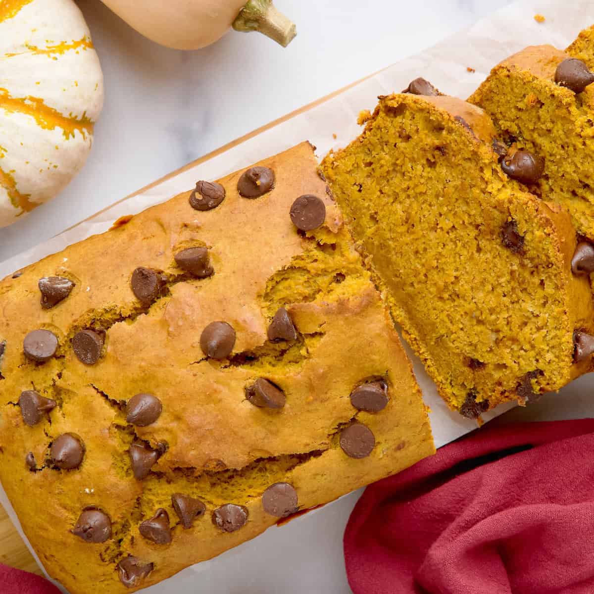 Banana pumpkin bread on a wooden board cut into slices