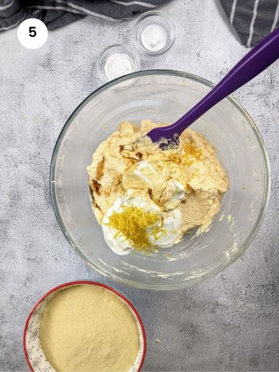 Adding the yogurt, lemon zest and vanilla extract to the batter.