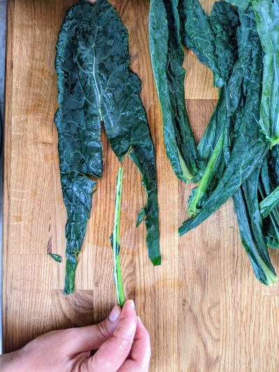 Removing cavolo nero kale stem.