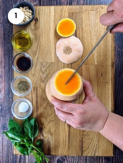 Cutting the butternut squash in half.