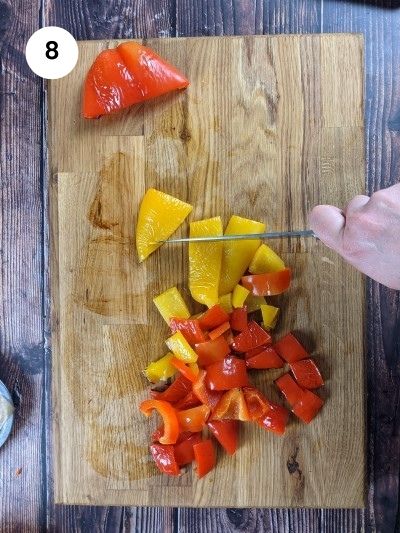 Cutting the roasted peppers into squares.