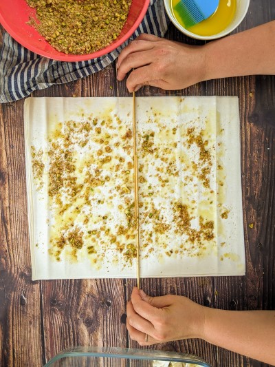 Placing wooden sticks in the middle of the filo pastry.