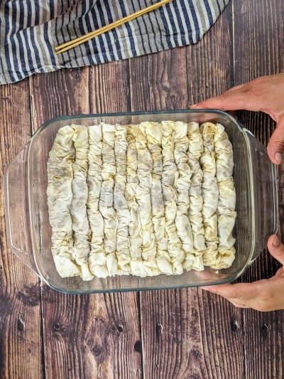 All baklava rolls in the ovenproof dish.