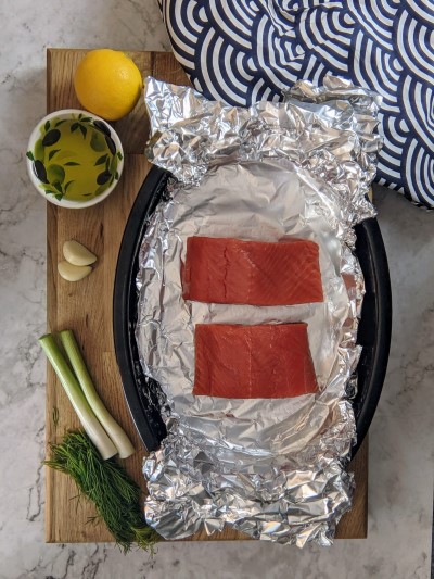 Salmon fillets placed on foil.