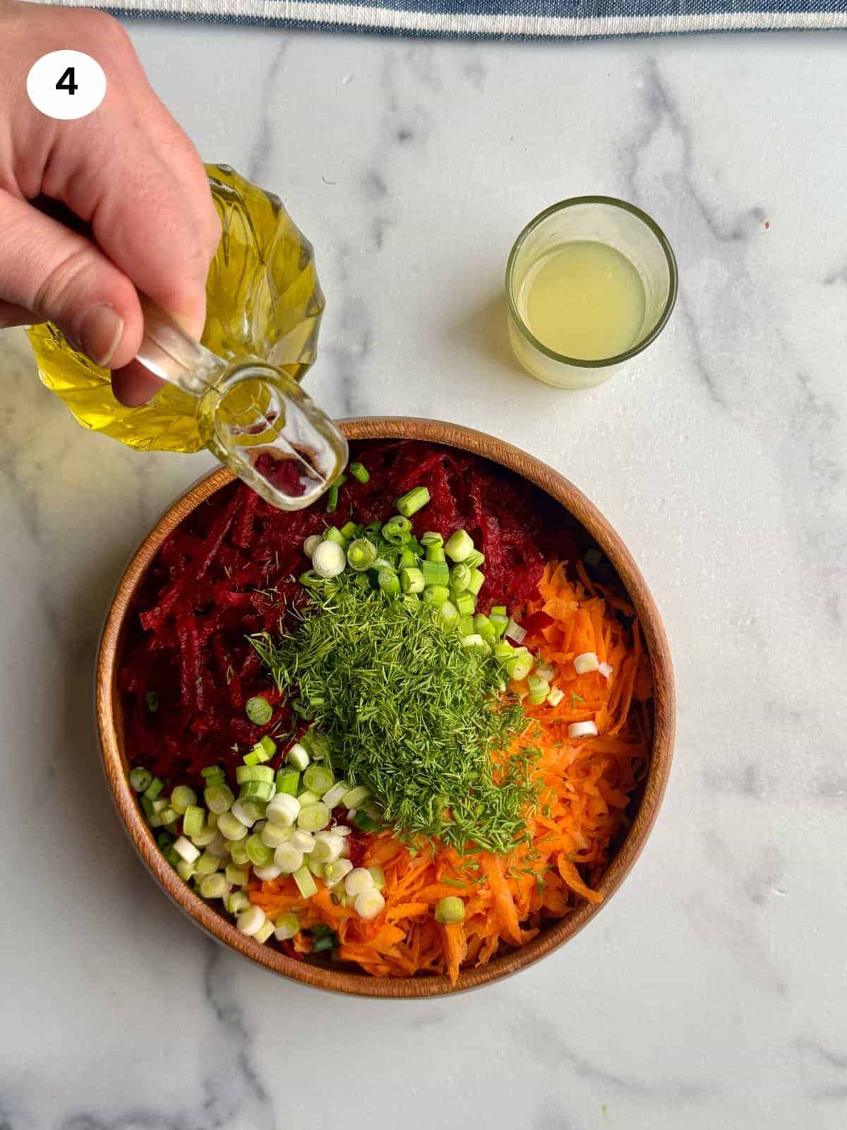 Adding olive oil to the salad.