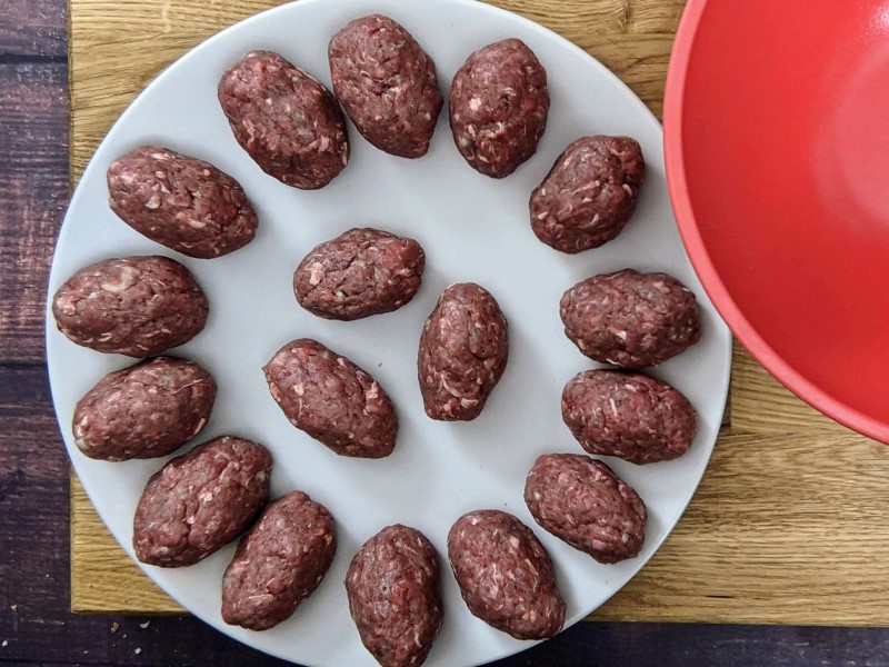 How to shape the soutzoukakia meatballs into oval shape.