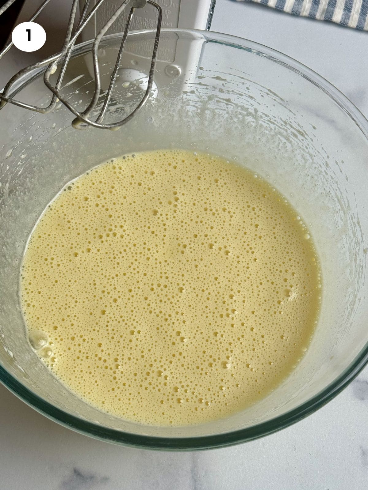 Mixing the eggs and oil with a hand mixer.