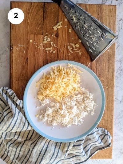 Grated cheese and crumbled feta for the Spinach & Cheese Muffins.