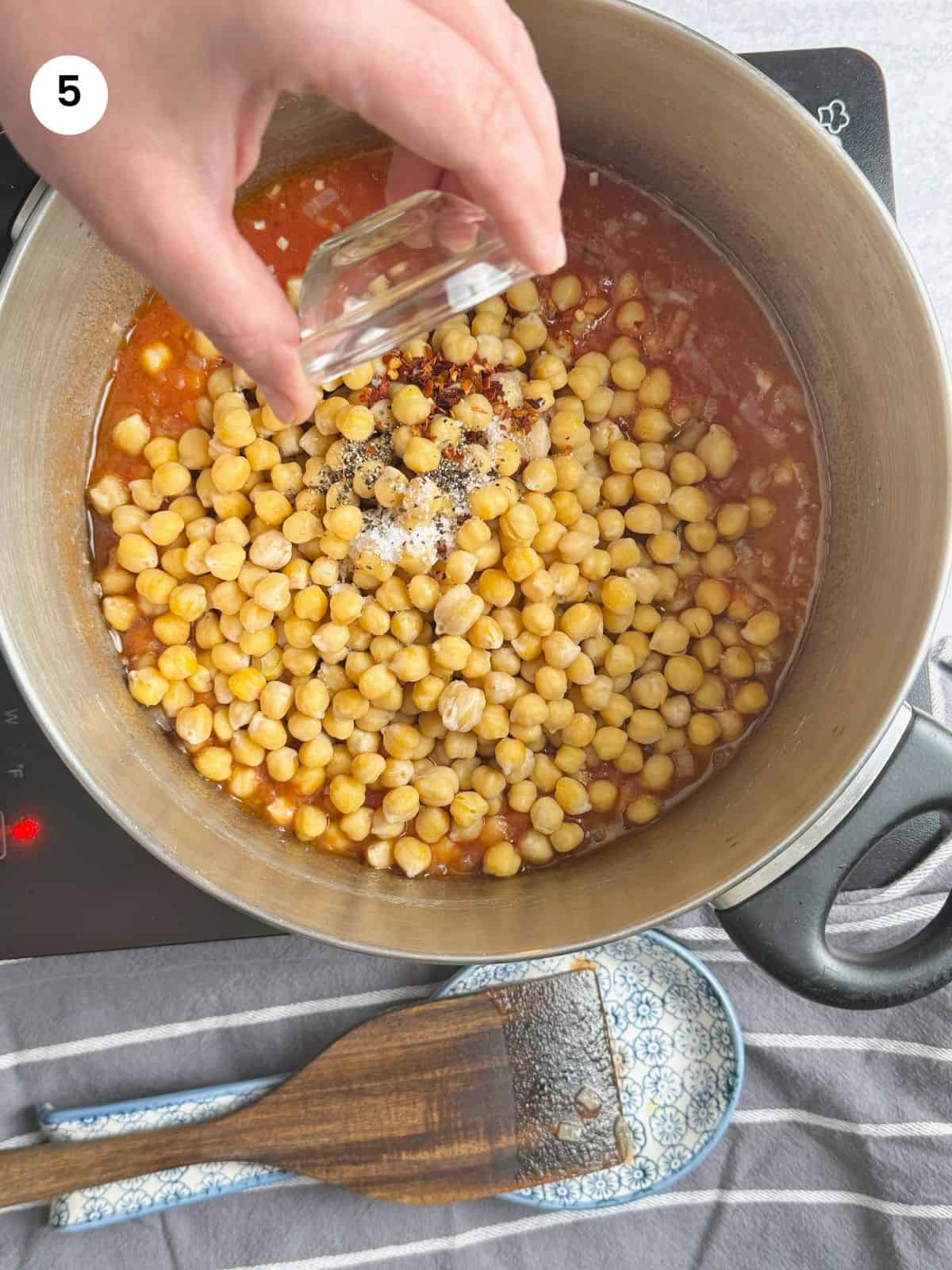 Adding spices to the pot.