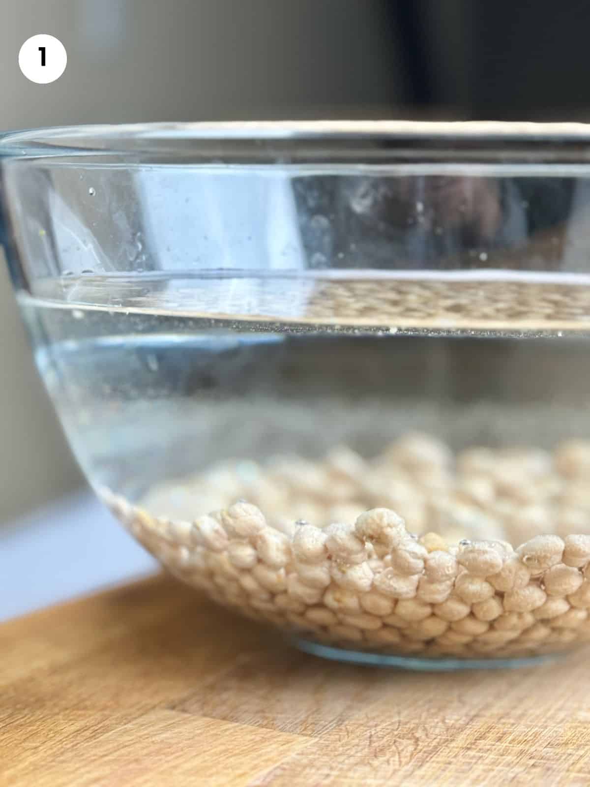Chickpeas in a bowl filled with water to rest overnight.