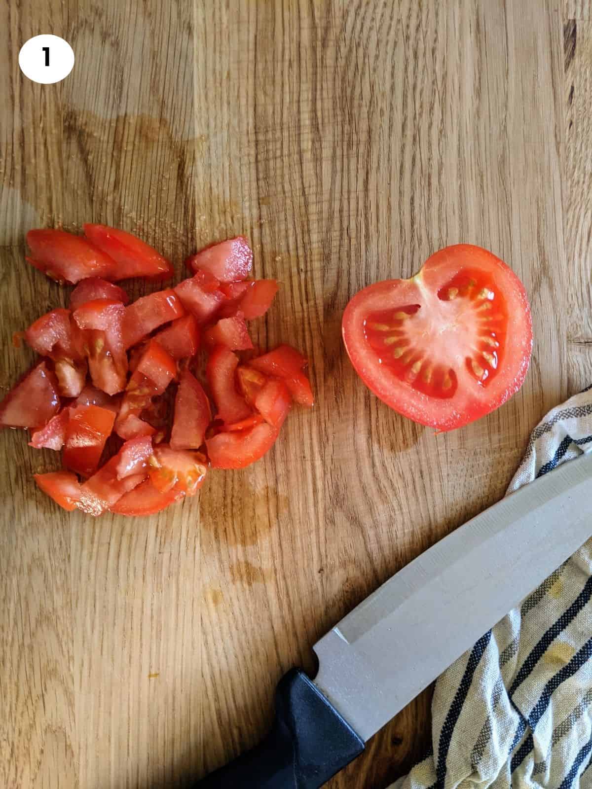 Chopping tomato for spinach and rice stew.