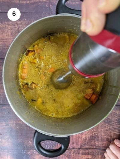 Adding the mix of spices to the veggies on the sheet pan.