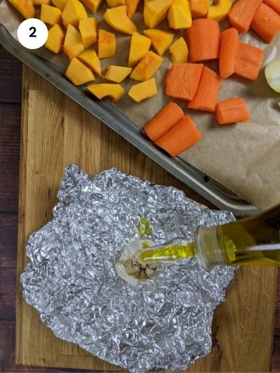 Drizzling the garlic head with olive oil and wrapping with foil.