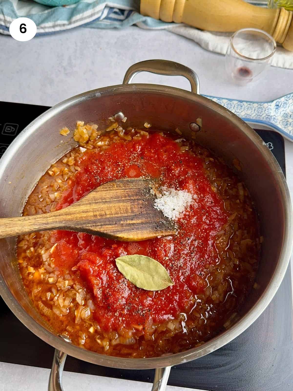 Added the chopped tomatoes to the pot.