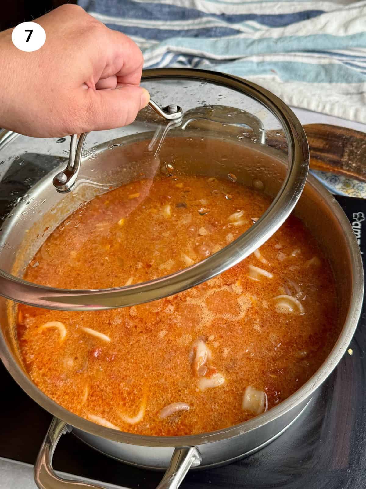 Added squid back to the pot to cook with tomatoes.