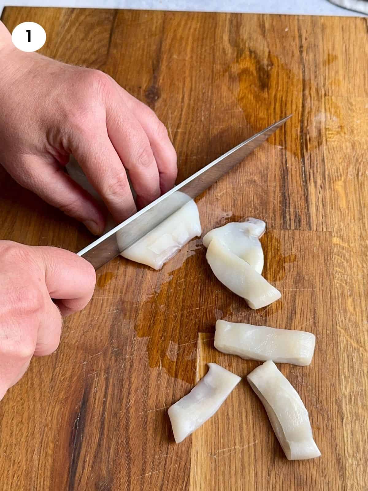 Cutting the calamari body into rings.