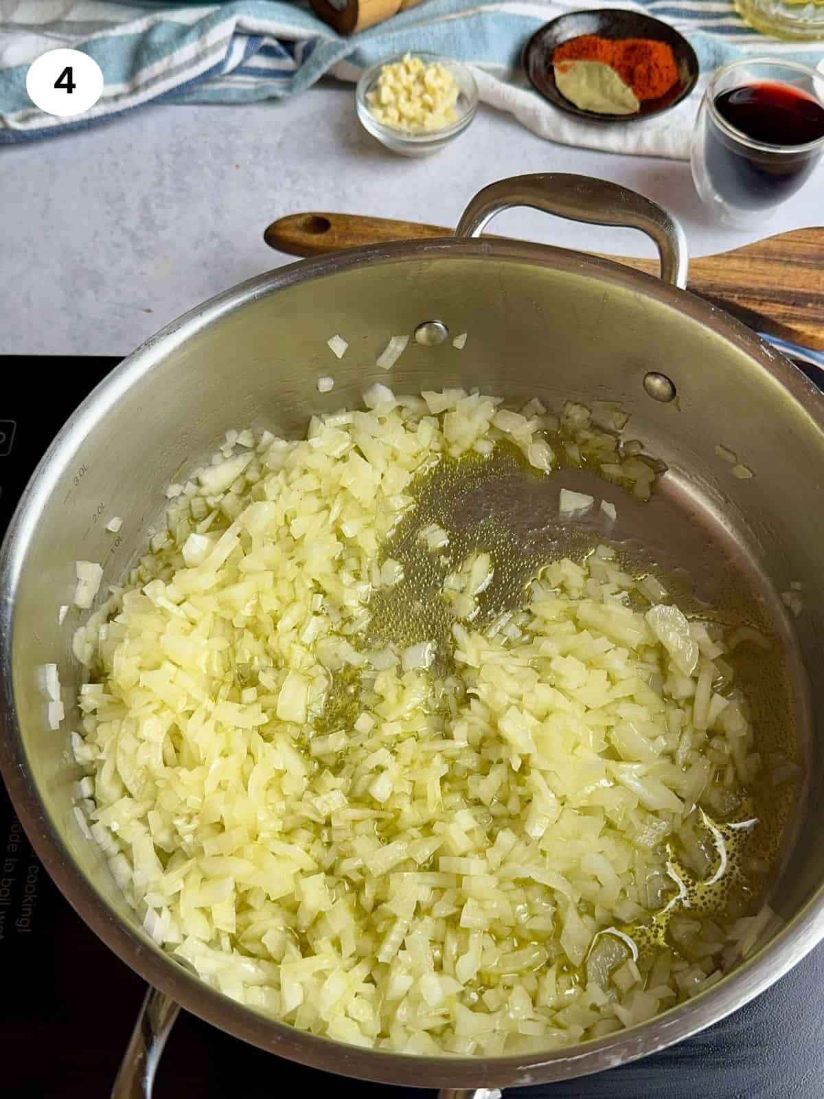 Sauteing the chopped onion in a pot.