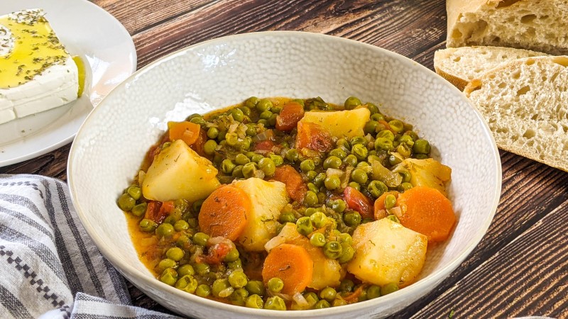 Peas, carrots and potatoes stew served in a bowl