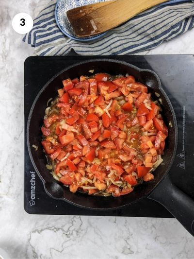 Adding the tomato cubes to the pan