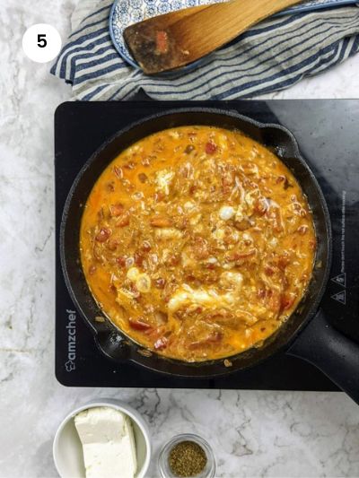 Adding the eggs to the pan.