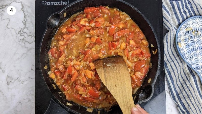 Cooking the tomatoes until all juices have evaporated.